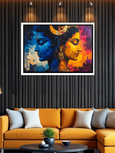 Colorful abstract painting of two faces on a wall above an orange sofa.