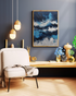 Abstract ocean wall art mounted above a sofa in a contemporary living room décor.