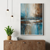 Contemporary abstract canvas art with blue and brown tones hanging above a wooden console table.