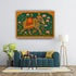 Decorative elephant painting on a wall above a teal sofa in a living room.