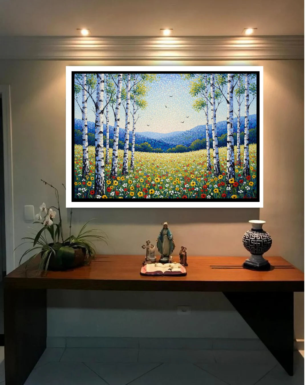 Decorative painting of trees and flowers on a wall above a wooden desk.