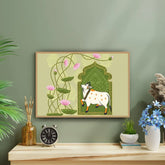 Framed artwork of a cow with floral design on a green wall above a wooden shelf.