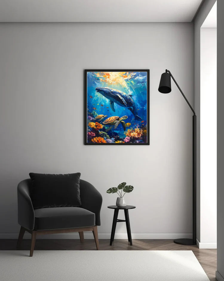 Living room with a dark gray armchair, small table with a plant, and a colorful whale painting on the wall.