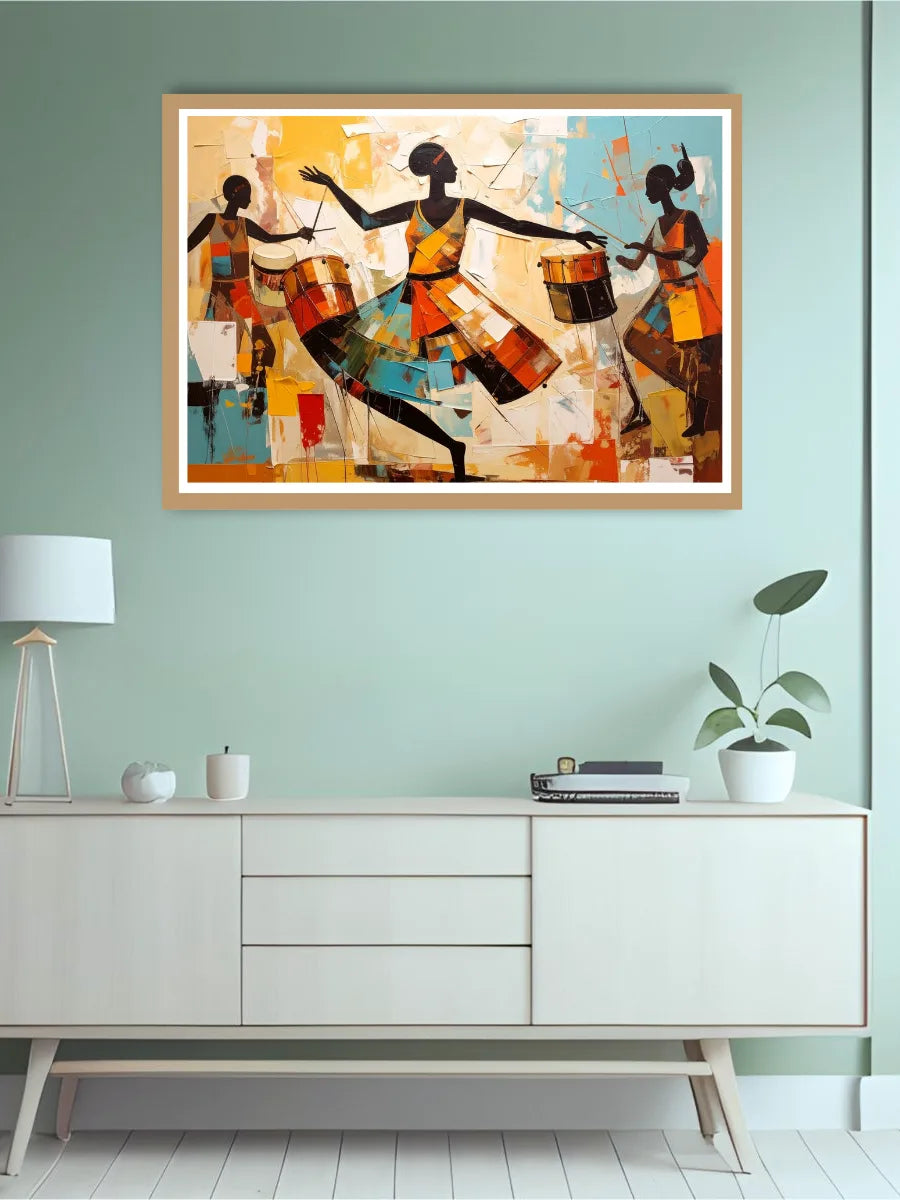 Framed abstract artwork of three figures playing drums on a light green wall above a white cabinet.