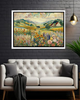 Framed artwork of a landscape with flowers and a house above a white sofa.