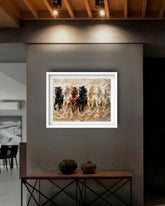 Framed artwork of horses on a wall in a modern interior setting.