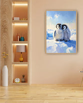 Framed artwork of two penguins on a snowy landscape in a room with wooden floor and shelves.