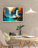 Framed painting of a mountain landscape with a deer on a wall above a desk.