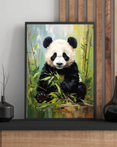 Framed painting of a panda bear sitting among bamboo on a wall.