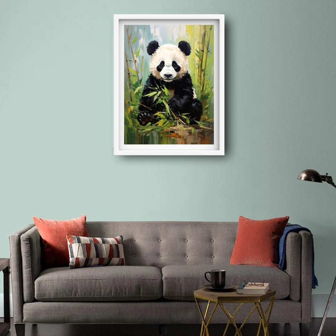 Framed painting of a panda bear on a wall above a gray sofa with red cushions.