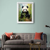 Framed painting of a panda bear on a wall above a gray sofa with red cushions.