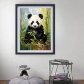 Framed painting of a panda bear sitting on a rock with bamboo in a room setting.