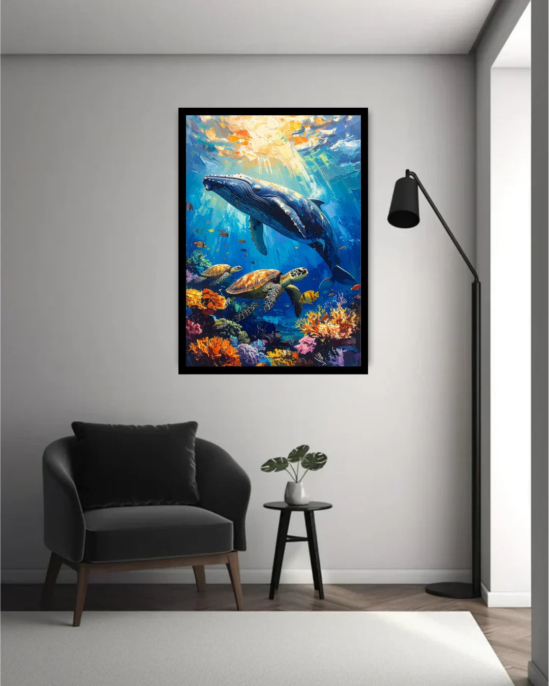 Framed underwater scene with a whale and fish hanging on a wall above a chair and table.