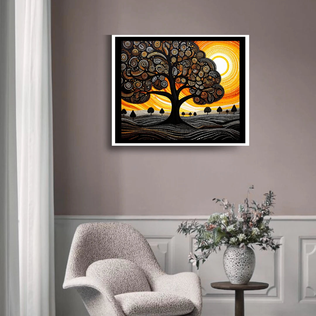 Framed abstract artwork of a tree with a sunset on a wall above a chair and table with a vase.