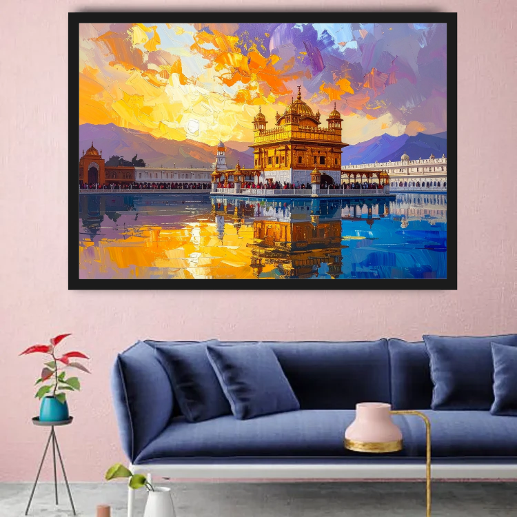 A framed art print depicting the Golden Temple in Amritsar, shown hanging on a pink wall above a blue sofa in a modern living room setting.