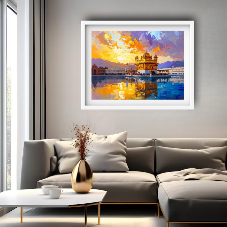 A framed art print of the Golden Temple in Amritsar, depicted in a vibrant orange and blue sunset sky, hanging on a gray wall above a modern gray sectional sofa in a living room setting.