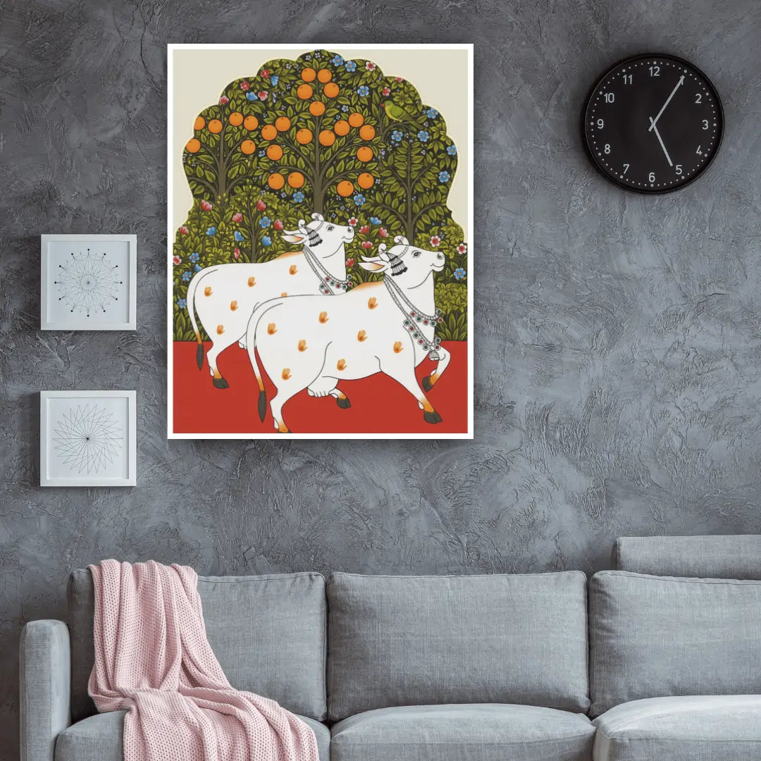 Decorative wall art of two white cows under an orange tree in a living room.