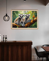 Framed artwork of two lemurs on a branch in a room with a wooden counter and chairs.