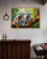 Framed artwork of two lemurs on a branch in a jungle setting, hanging on a wall above a wooden desk.