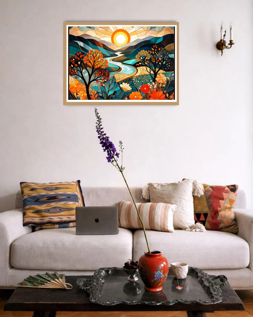 Living room with a colorful abstract painting above a sofa, laptop, and decorative items on a coffee table.