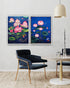 Two framed paintings of pink lotus flowers on a wall above a modern chair and dining table.