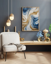 Modern blue and gold abstract wall art hanging above a wooden console in a neutral living space.