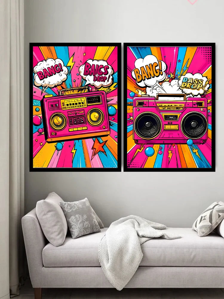 Two framed pop-art posters featuring retro boomboxes and comic-style speech bubbles hang above a light gray sofa in a living room setting.