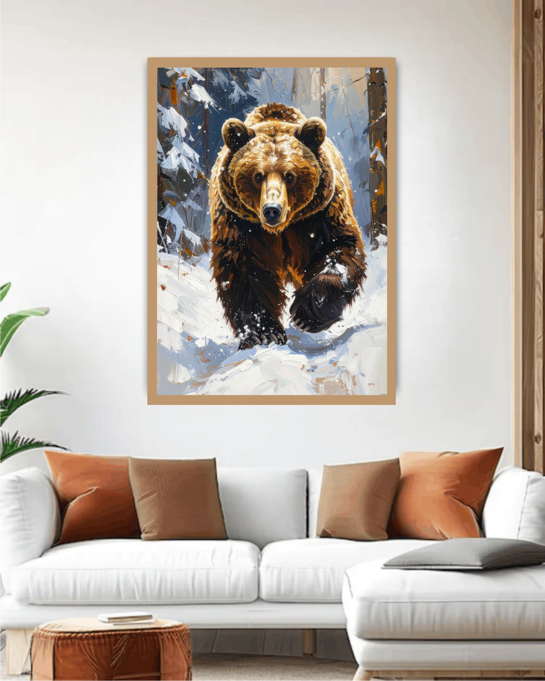 Framed artwork of a bear in a snowy landscape above a white sofa with brown and orange cushions.