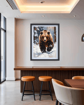 Framed picture of a bear in a snowy landscape hanging on a wall above a bar with stools and chairs.
