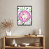 Framed artwork of a cow with flowers on a wall above a wooden shelf with decorative items.