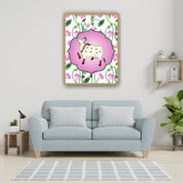 Light blue sofa in a living room with a framed picture of a cow on a floral background.