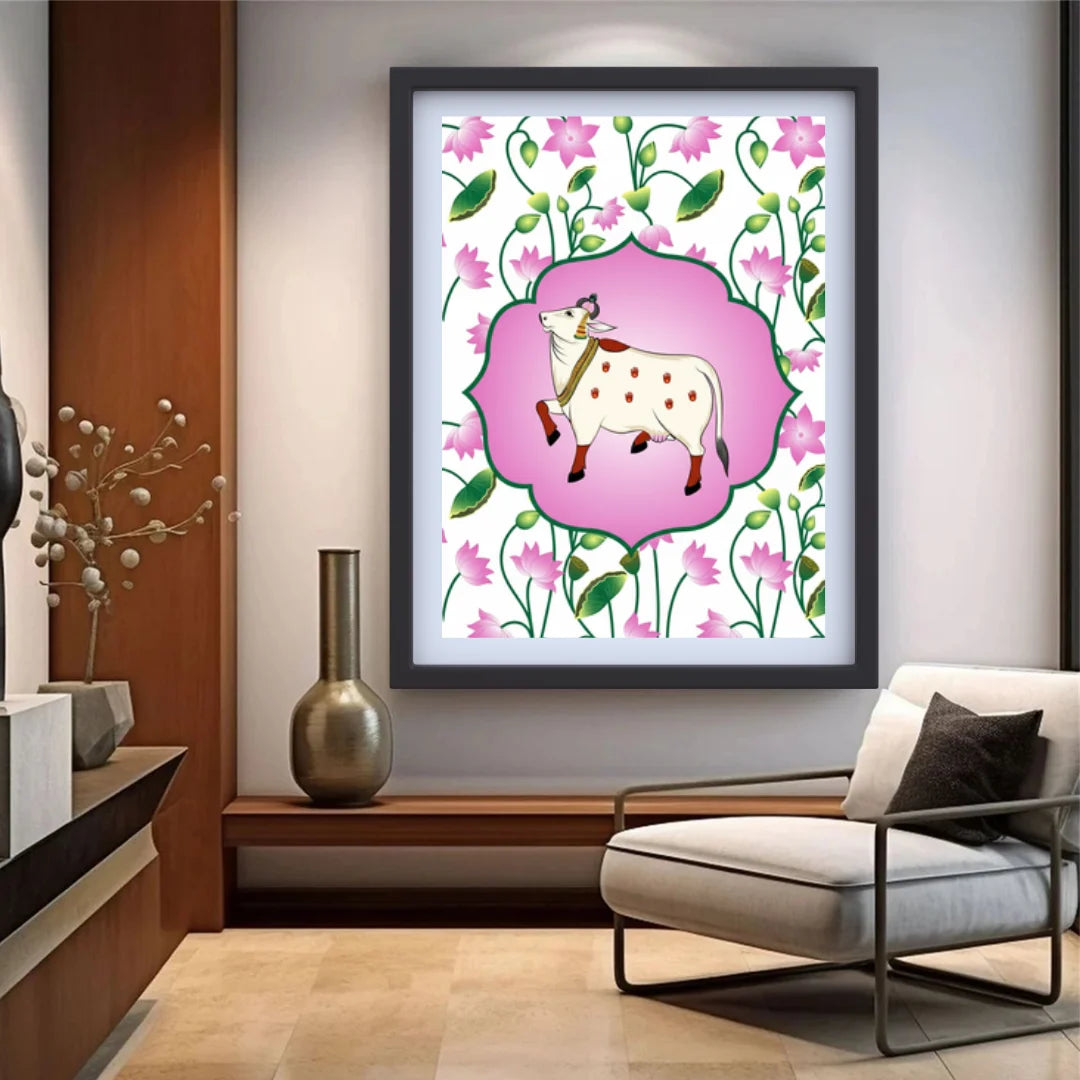 Framed artwork of a cow on a pink flower with floral patterns in a living room setting.