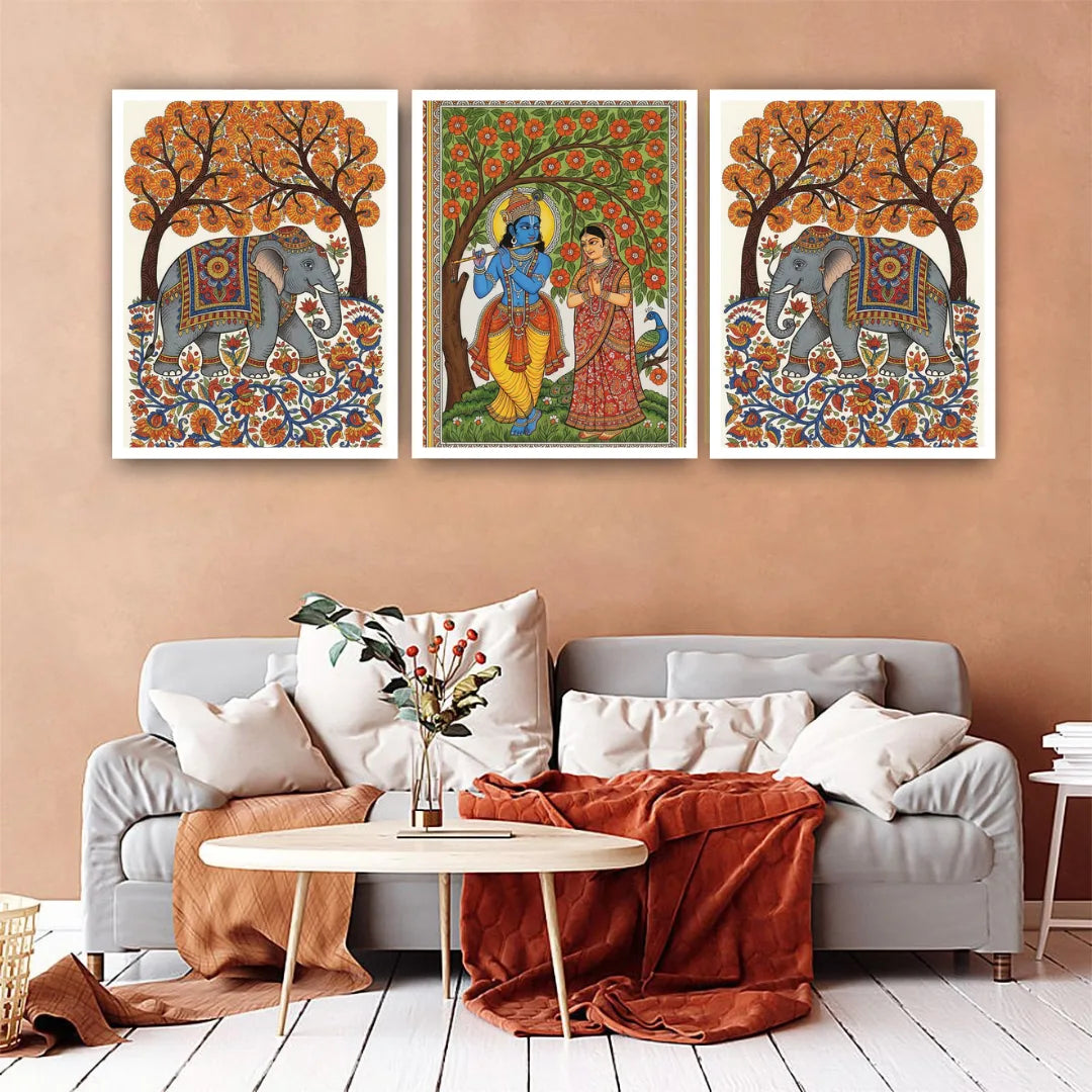 Living room with a sofa, coffee table, and wall art featuring elephants and traditional figures.