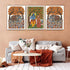 Living room with a sofa, coffee table, and wall art featuring elephants and traditional figures.