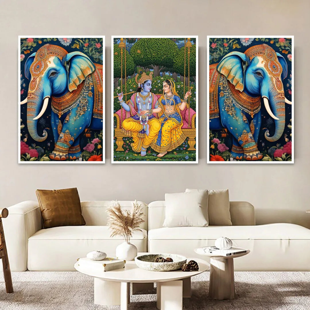 Three framed artworks of elephants and a couple on a wall above a white sofa.