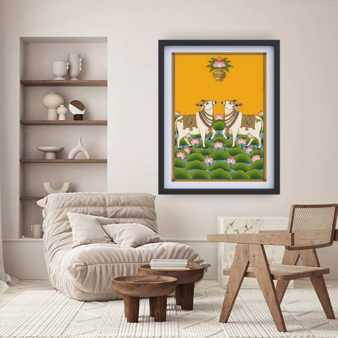Framed artwork of two cows on a yellow background in a living room setting.