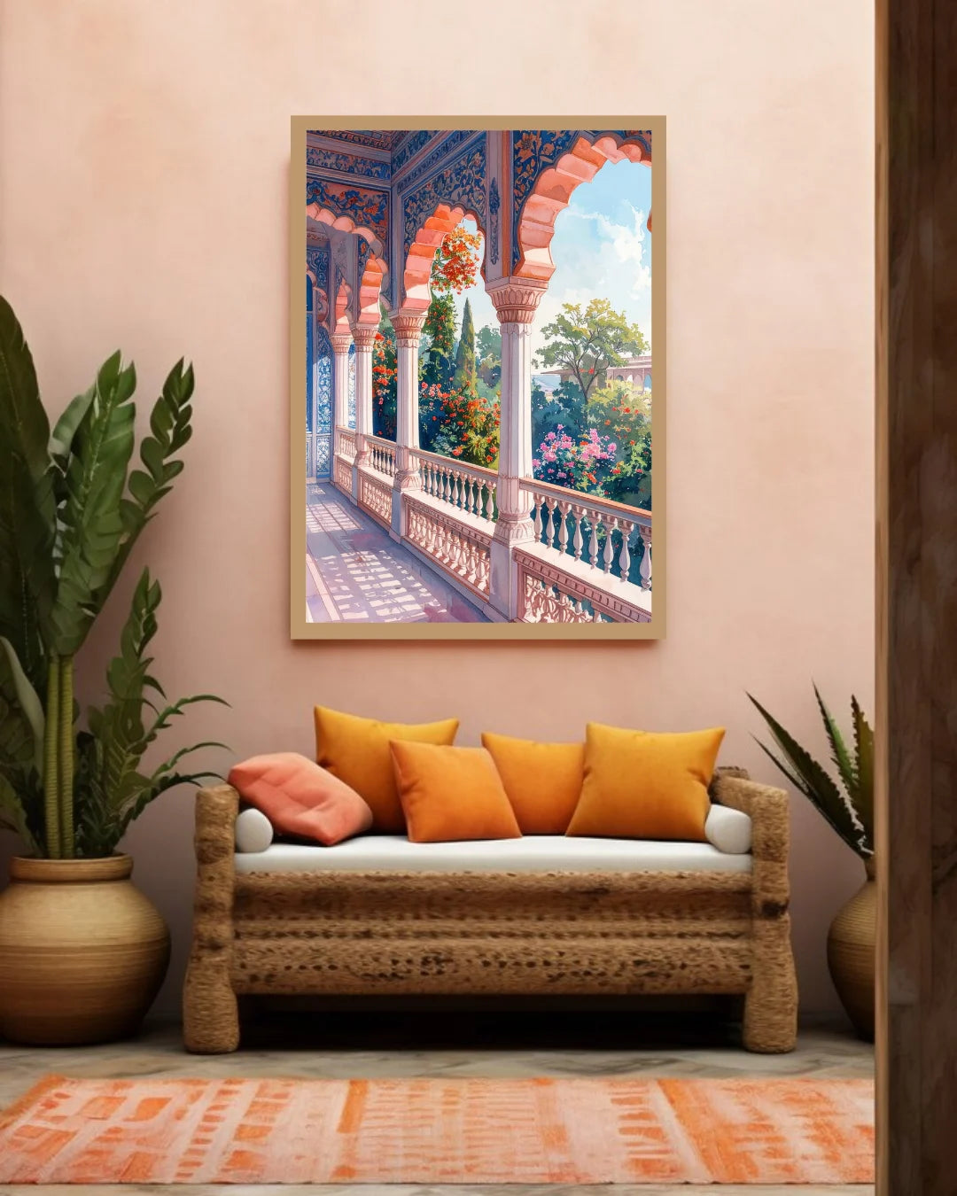 A framed art print depicting a colorful Mediterranean-style arched corridor with lush greenery, displayed on a warm beige wall above a woven rattan sofa with orange and pink pillows.