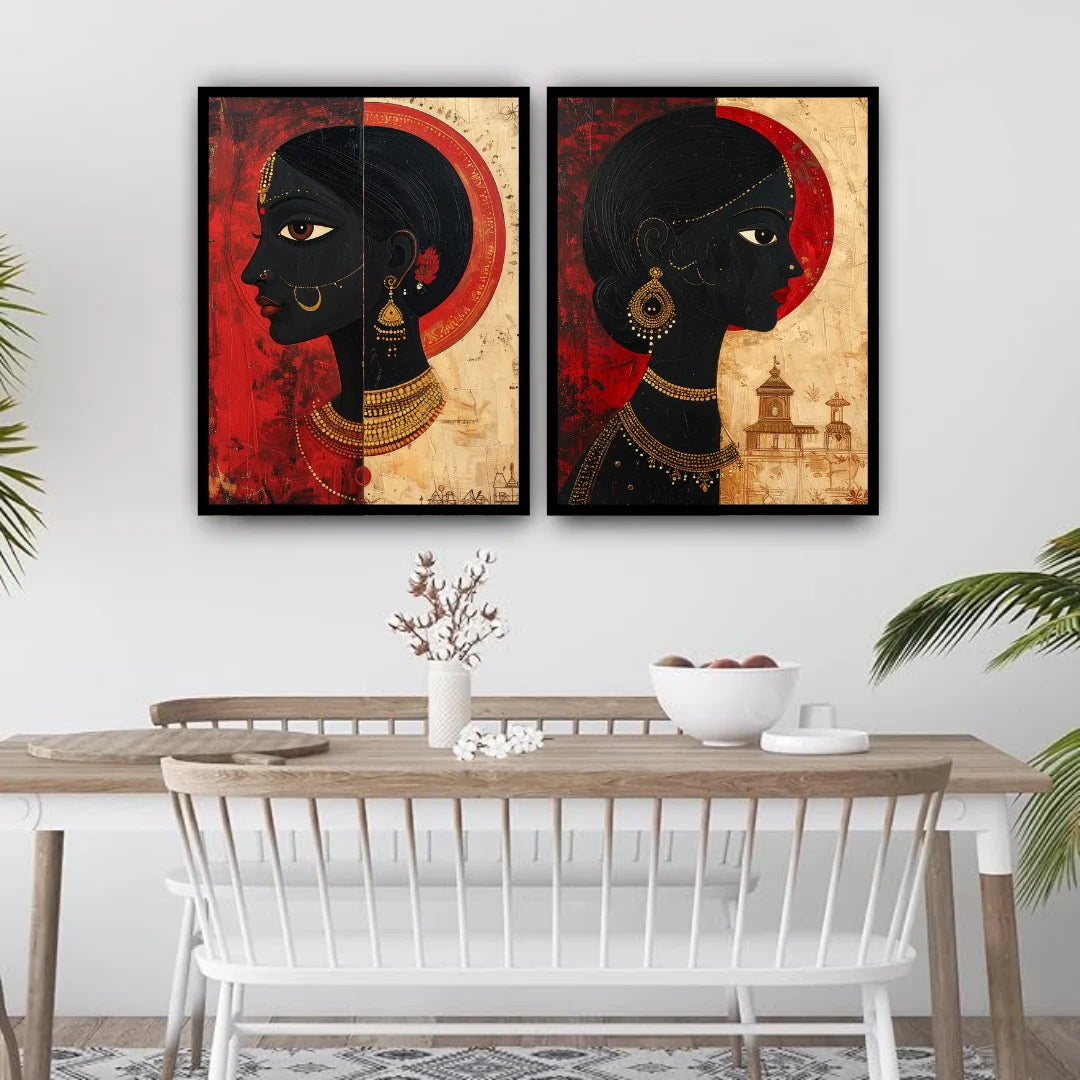 Two framed artworks of a stylized face on a wall above a dining table.