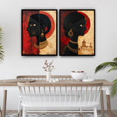 Two framed artworks of a stylized face on a wall above a dining table.