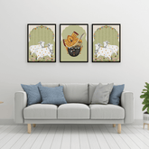 Gray sofa with blue and gray pillows in a room with framed artwork on the wall.