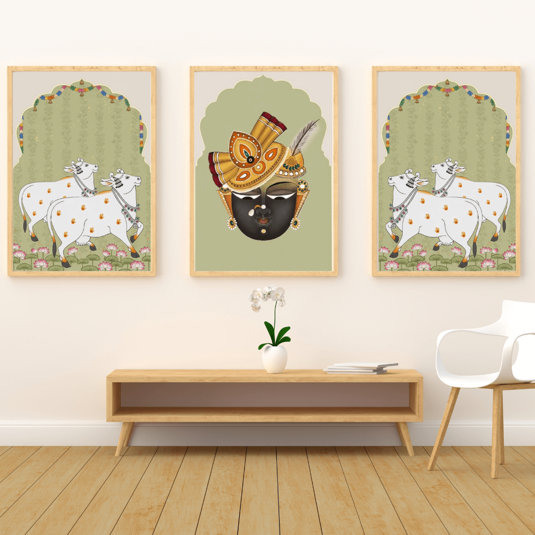 Three framed artworks on a wall above a wooden console table with a chair.