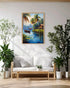 Living room with a tropical landscape painting above a white sofa, surrounded by plants.