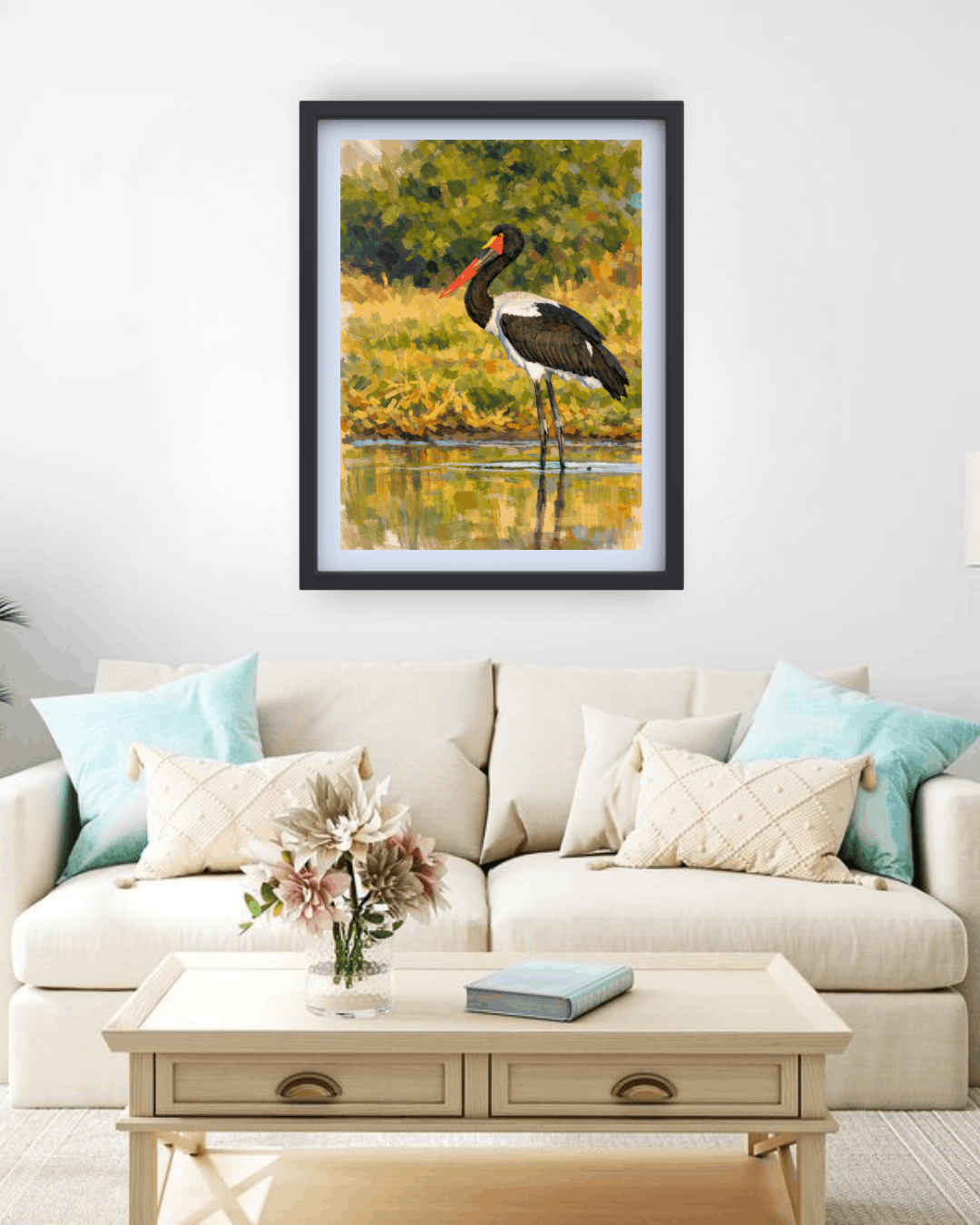 Framed picture of a bird on a wall above a sofa with decorative pillows.