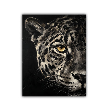 A square canvas art print featuring a close-up portrait of a leopard or snow leopard with striking yellow eyes against a dark background, shown on a plain white studio backdrop.