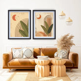 Living room with a brown sofa, decorative pillows, and two framed abstract art pieces on the wall.