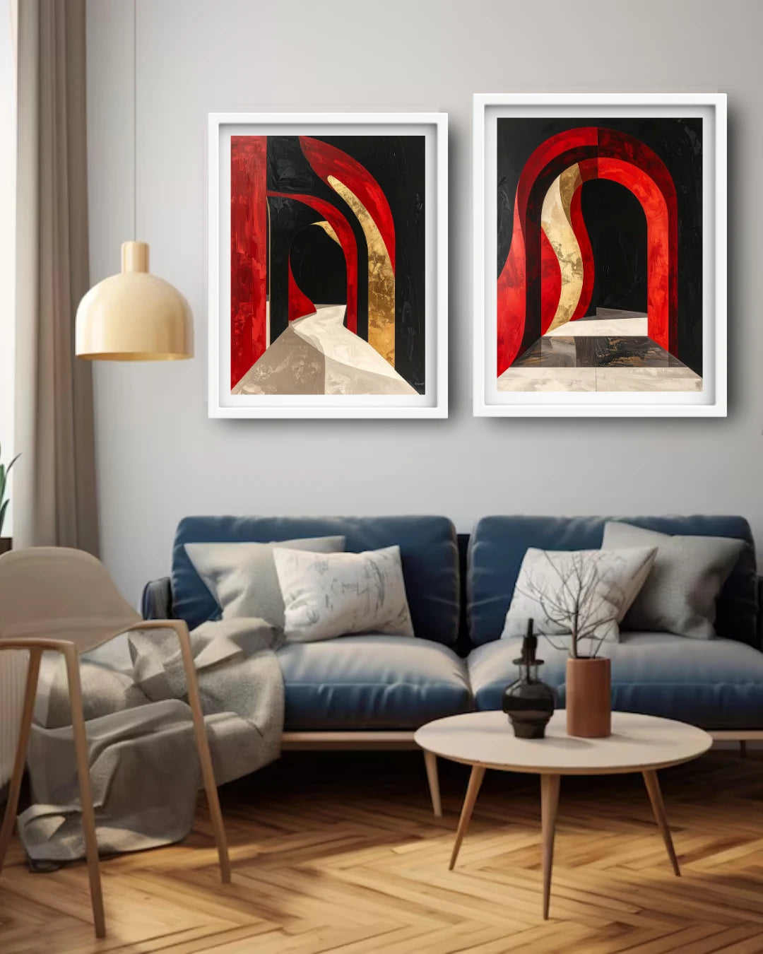 Two framed abstract wall art prints with red, black, and beige arch designs hang above a blue sofa in a modern living room setting.