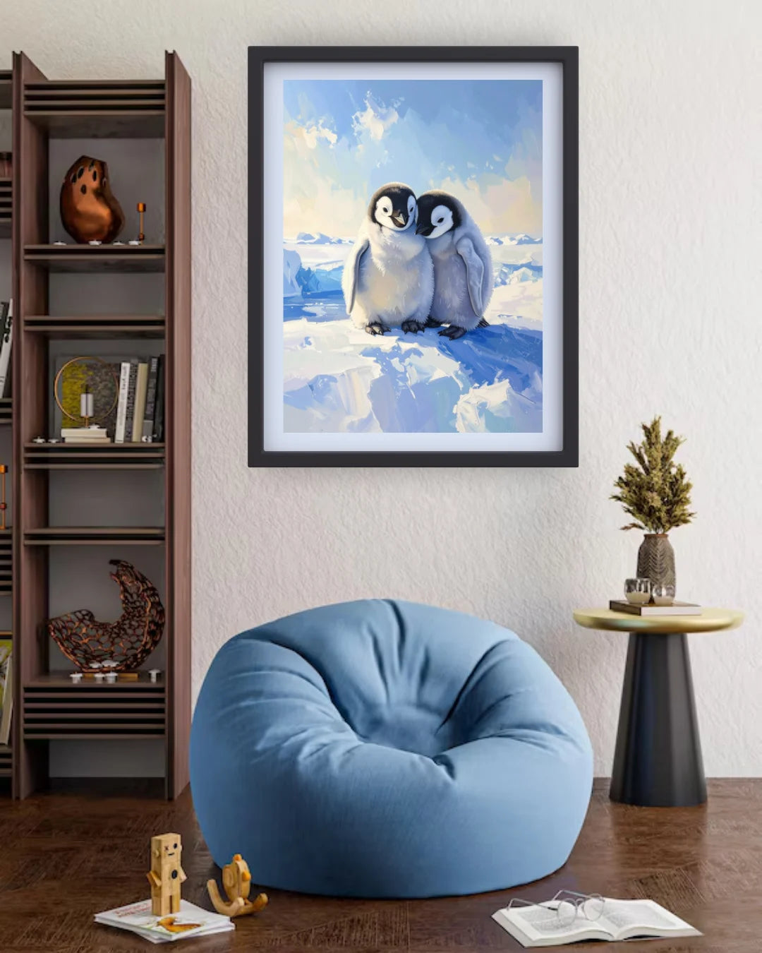 Framed artwork of penguins on ice in a room with a blue bean bag chair and bookshelf.
