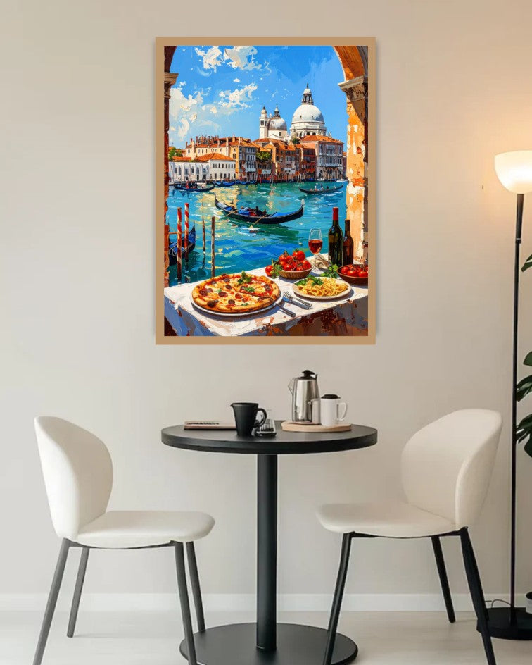 A framed art print depicting a scenic view of Venice with gondolas on a canal and pizza dishes on a table, displayed on a wall above a small dining table with two chairs.