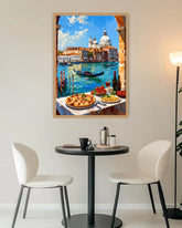 A framed art print depicting a scenic view of Venice with gondolas on a canal and pizza dishes on a table, displayed on a wall above a small dining table with two chairs.