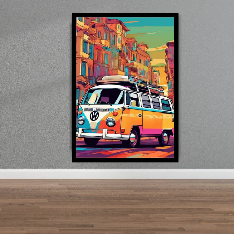A framed colorful pop-art poster of a vintage Volkswagen camper van driving through a city street, displayed on a gray wall above a wood floor.
